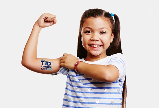 Child flexes arm with company logo on it.